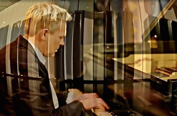 Pianist am Flügel in einer atmosphärischen Spiegelung